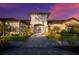 Elegant home exterior featuring stone accents, lush landscaping, and a welcoming paved walkway to the entrance at 5510 Panella Ct, Palmetto, FL 34221