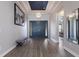 Elegant foyer with tray ceilings, chandelier lighting, and wood flooring leading to double front doors at 5510 Panella Ct, Palmetto, FL 34221