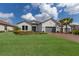 Beautiful home featuring a well-manicured lawn, brick driveway, and a two-car garage at 5510 Panella Ct, Palmetto, FL 34221
