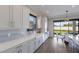 Bright kitchen featuring modern white cabinets, stainless steel appliances, and a dining area at 5510 Panella Ct, Palmetto, FL 34221