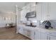 Modern kitchen featuring white cabinets, stainless steel appliances, and a view into dining area at 5510 Panella Ct, Palmetto, FL 34221