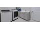 Laundry room with white washer, dryer, sink, and white cabinets at 5510 Panella Ct, Palmetto, FL 34221