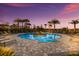 Resort-style pool with palm trees and lounge chairs offers a relaxing oasis at twilight at 5510 Panella Ct, Palmetto, FL 34221