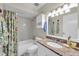 Bathroom with a shower and tub combo, granite countertop, and decorative floral shower curtain at 835 Audubon Dr # 835, Bradenton, FL 34209