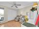 Bright bedroom with wood floors, a window, and two comfortable recliners near a white desk and closet at 835 Audubon Dr # 835, Bradenton, FL 34209
