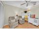 Cozy bedroom featuring two plush recliners, a ceiling fan, and a bright yellow desk setup at 835 Audubon Dr # 835, Bradenton, FL 34209