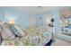 Light and airy bedroom with floral bedding and ceiling fan at 835 Audubon Dr # 835, Bradenton, FL 34209