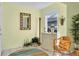 Inviting entryway with wicker chair, decorative console table, and potted plants at 835 Audubon Dr # 835, Bradenton, FL 34209