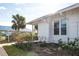 White exterior of home with walkway, landscaping, and palm trees at 835 Audubon Dr # 835, Bradenton, FL 34209