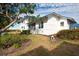 White house with blue roof and landscaped yard near the water at 835 Audubon Dr # 835, Bradenton, FL 34209