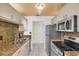 Modern kitchen featuring granite countertops and stainless steel appliances at 835 Audubon Dr # 835, Bradenton, FL 34209