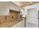 Modern kitchen with granite countertops, stainless steel appliances, and ample cabinet space at 835 Audubon Dr # 835, Bradenton, FL 34209