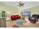 Bright living room with comfy seating, colorful rug, and high ceilings at 835 Audubon Dr # 835, Bradenton, FL 34209
