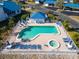 Aerial view of a community pool area with lounge chairs and tables for relaxing poolside at 835 Audubon Dr # 835, Bradenton, FL 34209