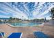 Inviting community pool area with lounge chairs at 835 Audubon Dr # 835, Bradenton, FL 34209