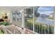 Peaceful screened balcony with wicker chair and view of the water at 835 Audubon Dr # 835, Bradenton, FL 34209