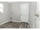 Bright laundry room with wood-look flooring and access door at 19394 Villanova Ave, Port Charlotte, FL 33954