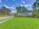 Beautiful community entrance sign with vibrant landscaping and towering palm trees under a sunny sky at 2023 Mesic Hammock Way, Venice, FL 34292