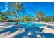 Resort-style pool with plenty of lounge chairs and palm trees for a relaxing experience at 2023 Mesic Hammock Way, Venice, FL 34292