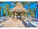 Outdoor kitchen with covered seating perfect for grilling and entertaining friends and Gathering at 2023 Mesic Hammock Way, Venice, FL 34292