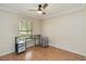 Bedroom featuring hard wood floors, ceiling fan and a large window for plenty of light at 4337 Mermell Cir, North Port, FL 34291
