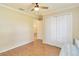 Spare bedroom with a closet, wood laminate flooring, and a modern ceiling fan at 4337 Mermell Cir, North Port, FL 34291
