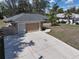 Well-kept single-story home with attached garage and spacious concrete driveway at 4337 Mermell Cir, North Port, FL 34291