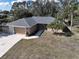 Inviting single-story home featuring a well-maintained lawn and mature palm trees at 4337 Mermell Cir, North Port, FL 34291