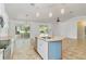 Updated kitchen with stainless steel appliances, granite counters, and an island with seating at 4337 Mermell Cir, North Port, FL 34291