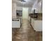 Kitchen with stainless steel appliances, white cabinets, an island, and tile flooring at 4337 Mermell Cir, North Port, FL 34291