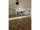 Open-concept living area with tile floors flows into a modern kitchen with white cabinetry and an island at 4337 Mermell Cir, North Port, FL 34291