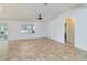 Open living room with neutral tile floors, lots of light, and vaulted ceiling at 4337 Mermell Cir, North Port, FL 34291