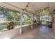 Spacious screened porch with views of the landscaped backyard with ample sunlight and potted plants at 4337 Mermell Cir, North Port, FL 34291