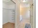 Bright walk-in closet with custom shelving adjacent to a well-lit bathroom with modern fixtures and tile flooring at 4337 Mermell Cir, North Port, FL 34291