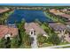 Luxury home with lake view and lush landscaping in a gated community at 7216 Prestbury Cir, Lakewood Ranch, FL 34202
