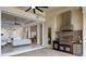 Outdoor kitchen and living area with a view through sliding doors at 7216 Prestbury Cir, Lakewood Ranch, FL 34202