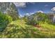 Expansive backyard with mature trees and landscaping at 1362 Hedgewood Cir, North Port, FL 34288