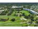Scenic aerial view of condo buildings surrounded by a well-maintained golf course and ponds at 4480 Fairways Blvd # 109, Bradenton, FL 34209
