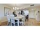 Bright dining room with white table and chairs, hardwood floors, and large artwork at 4480 Fairways Blvd # 109, Bradenton, FL 34209