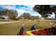 Picturesque golf course scene with a golfer and vibrant flowers in the foreground at 4480 Fairways Blvd # 109, Bradenton, FL 34209