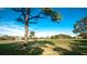 Beautiful golf course with lush green grass and mature trees under a bright blue sky at 4480 Fairways Blvd # 109, Bradenton, FL 34209
