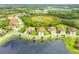 Aerial view showcases home's location in a community by a lake at 212 Casalino Dr, Nokomis, FL 34275