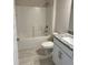 Bathroom featuring a shower-tub combination, granite vanity top, and modern fixtures at 2628 Averland Loop, North Port, FL 34287