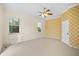 Spacious bedroom with a ceiling fan and patterned wallpaper at 7565 Palmer Glen Cir, Sarasota, FL 34240