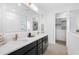 Elegant bathroom with double vanity, large mirror, and walk in closet at 1119 Waterline Ct, Sarasota, FL 34240