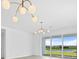 Bright dining room with large windows and modern light fixtures at 1119 Waterline Ct, Sarasota, FL 34240