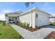 One-story home with white exterior, two-car garage, and landscaped front yard at 1119 Waterline Ct, Sarasota, FL 34240