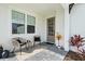 Inviting front porch with seating area and modern door at 1119 Waterline Ct, Sarasota, FL 34240