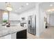 Modern kitchen with white cabinets, granite counters, and stainless steel appliances at 1119 Waterline Ct, Sarasota, FL 34240