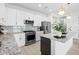 Spacious kitchen with white cabinets, granite countertops, and island at 1119 Waterline Ct, Sarasota, FL 34240